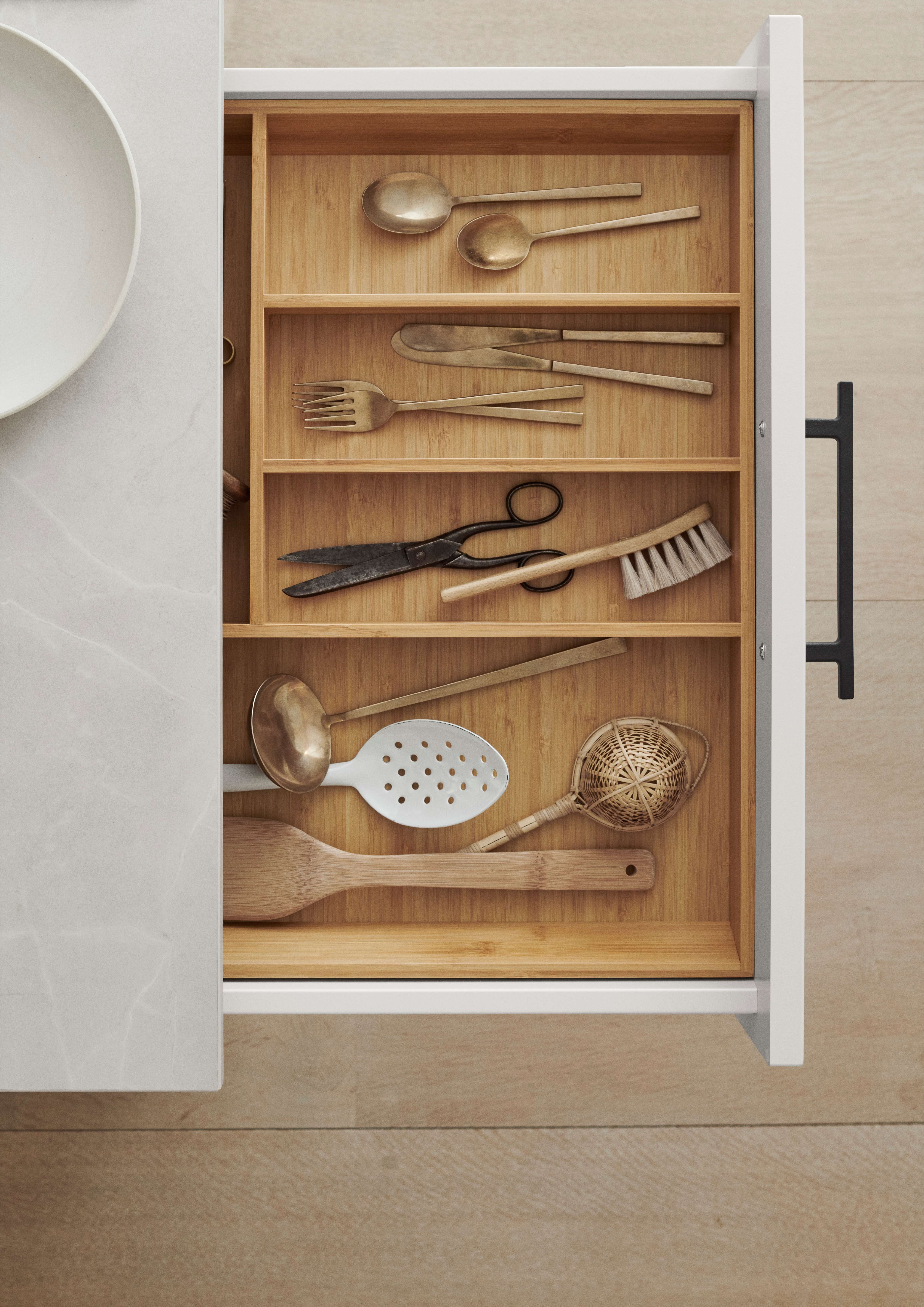 White kitchen rawer with a bamboo insert for the kitchen cutlery